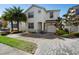 Two-story house with a white exterior, two palm trees, and a brick driveway at 4738 Sleepy Hollow Dr, Kissimmee, FL 34746