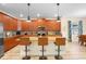 Modern kitchen with wood cabinets, granite countertops, and island at 4738 Sleepy Hollow Dr, Kissimmee, FL 34746