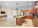 Modern kitchen with wood cabinets, granite countertops, and island at 4738 Sleepy Hollow Dr, Kissimmee, FL 34746