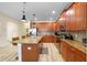 Modern kitchen with wood cabinets, granite countertops, and island at 4738 Sleepy Hollow Dr, Kissimmee, FL 34746