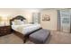Main bedroom with king-size bed and sitting bench at 4738 Sleepy Hollow Dr, Kissimmee, FL 34746