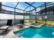 Screened-in pool and spa area with lounge chairs at 4738 Sleepy Hollow Dr, Kissimmee, FL 34746