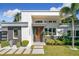 Modern home with a stylish facade, featuring a blend of white and dark wood accents, and a well-manicured lawn at 1123 Webster Ave, Orlando, FL 32804