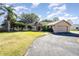 Single-story home with a two-car garage and landscaped lawn at 12504 Blue Heron Way, Leesburg, FL 34788