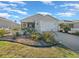 House exterior with landscaping and a white picket fence at 1398 Zest Ave, The Villages, FL 32163