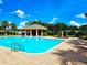 Community pool with a gazebo and plenty of lounge space at 223 Bexley Dr, Davenport, FL 33897