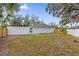 Large backyard with mature trees and wooden fence at 3553 Greenfield Ave, Orlando, FL 32808