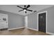 Bright bedroom with ceiling fan, new flooring, and modern door at 3553 Greenfield Ave, Orlando, FL 32808