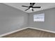 Bedroom with wood-look floors, ceiling fan and window at 3553 Greenfield Ave, Orlando, FL 32808