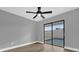 Bedroom with wood-look floors, ceiling fan and sliding glass doors leading to a pool at 3553 Greenfield Ave, Orlando, FL 32808