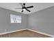Bedroom with wood-look floors, ceiling fan and window at 3553 Greenfield Ave, Orlando, FL 32808