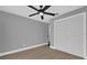 Spacious bedroom with wood-look floors and ceiling fan at 3553 Greenfield Ave, Orlando, FL 32808