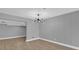 Bright dining room with gray walls, wood floors, and a modern chandelier at 3553 Greenfield Ave, Orlando, FL 32808