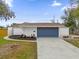 Newly renovated home with fresh landscaping and a modern garage door at 3553 Greenfield Ave, Orlando, FL 32808