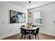 Bright dining area with wood table and four emerald green chairs at 3617 Epperstone Ct, Apopka, FL 32712