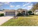 Single-story house with a two-car garage and well-maintained lawn at 3814 Manor Oaks Ct, Leesburg, FL 34748