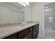 Double vanity bathroom with granite countertop and a walk-in shower at 866 Paradise Dr, Davenport, FL 33897
