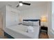 King bedroom with white walls and a navy blue bedspread at 866 Paradise Dr, Davenport, FL 33897