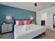 Primary bedroom with a plush bed, coral pillows, and ensuite bathroom at 866 Paradise Dr, Davenport, FL 33897