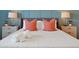 Bright bedroom with a plush bed, coral pillows, and nightstands at 866 Paradise Dr, Davenport, FL 33897