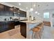 Modern kitchen with dark cabinets, granite counters, and island seating at 866 Paradise Dr, Davenport, FL 33897