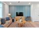 Living room features a blue accent wall, comfy seating, and a large TV at 866 Paradise Dr, Davenport, FL 33897