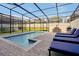 Private screened pool with lounge chairs and grill at 866 Paradise Dr, Davenport, FL 33897