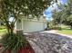 Two-car garage with brick paver driveway and landscaping at 9026 Paolos Pl, Kissimmee, FL 34747