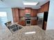 Modern kitchen with stainless steel appliances and granite countertops at 9026 Paolos Pl, Kissimmee, FL 34747