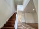 Bright, open staircase with wood steps and white railing at 9026 Paolos Pl, Kissimmee, FL 34747