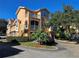 Two-story condo building with multiple units, parking, and landscaping at 12020 Villanova Dr # 101, Orlando, FL 32837