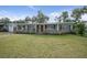 Single story home with red door and lush green lawn at 1944 Bering Ave, Winter Park, FL 32789