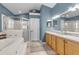 Bathroom with double sinks, shower, and a garden tub at 1965 Fairway Loop, Kissimmee, FL 34746