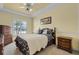 Cozy bedroom with a ceiling fan and ample closet space at 1965 Fairway Loop, Kissimmee, FL 34746