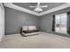 Spacious bedroom with neutral walls and a small loveseat at 1965 Fairway Loop, Kissimmee, FL 34746