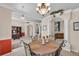 Bright dining room features a table with four chairs, and views into the kitchen and living room at 1965 Fairway Loop, Kissimmee, FL 34746