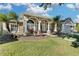 One-story house with a large front porch and lush landscaping at 1965 Fairway Loop, Kissimmee, FL 34746