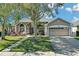 One-story home with a two-car garage and landscaped yard at 1965 Fairway Loop, Kissimmee, FL 34746