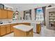 Large kitchen with an island, plenty of cabinets, and views to the breakfast nook and Gathering room at 1965 Fairway Loop, Kissimmee, FL 34746
