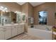 Elegant bathroom with double vanity, soaking tub, and separate shower at 27000 Nature View St, Leesburg, FL 34748