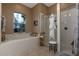 Spa-like bathroom with soaking tub, walk-in shower, and plenty of storage at 27000 Nature View St, Leesburg, FL 34748