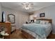 Guest bedroom with queen-size bed and wicker furniture at 27000 Nature View St, Leesburg, FL 34748