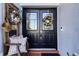 Double front doors with decorative wreaths and side seating at 27000 Nature View St, Leesburg, FL 34748