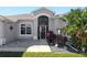 Inviting front entrance with a paved walkway and landscaping at 27000 Nature View St, Leesburg, FL 34748