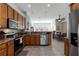 Large kitchen with stainless steel appliances and an eat-in area at 27000 Nature View St, Leesburg, FL 34748