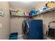 Convenient laundry room with washer, dryer, and storage shelves at 27000 Nature View St, Leesburg, FL 34748