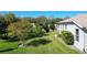 Landscaped side yard with mature trees and shrubs at 27000 Nature View St, Leesburg, FL 34748
