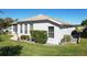 Landscaped side yard with mature trees and shrubs at 27000 Nature View St, Leesburg, FL 34748