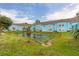 Serene pond with lush landscaping and community building views at 2743 N Poinciana Blvd # 59, Kissimmee, FL 34746