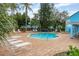 Community pool with lounge chairs and surrounding landscaping at 2743 N Poinciana Blvd # 59, Kissimmee, FL 34746